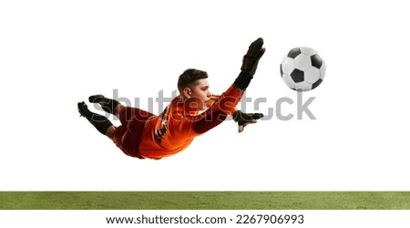Dynamic portrait of professional soccer goalkeeper in sports uniform jumping and catching football ball isolated over white background. Concept of sport, action, motion, goals.