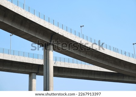 Elevated expressway during a sunny day .  highway overpass against blue sky .  Motorway viaduct interchange Royalty-Free Stock Photo #2267913397
