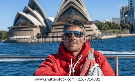 Happy tourist with Sydney skyline in the background.