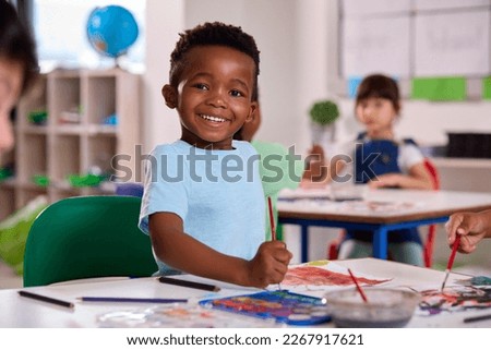 Classroom Portrait Of Smiling Male Elementary School Pupil In Art Class At School Royalty-Free Stock Photo #2267917621