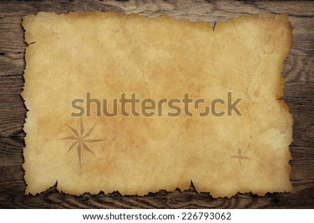 Pirates' old parchment treasure map on wood background