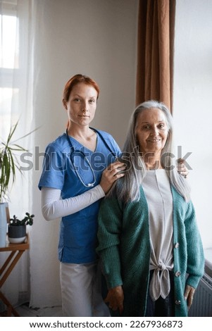 Portrait of senior nurse and senior woman in her home.
