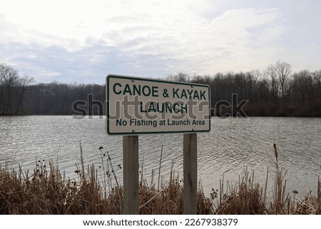 A close view of the green and white canoe kayak launch sign.