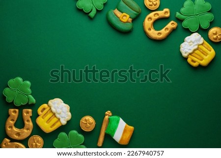 Banner for St. Patrick's Day on green background. Coins, horseshoes, four-leaf clover as symbols of the holiday. Place for text. Gingerbread cookie items.