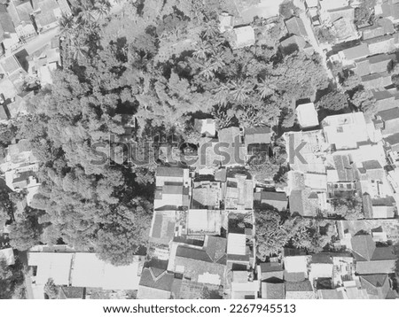 Black and white aerial photo of a residential district surrounded by trees in Bandung - Indonesia.