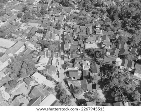 Black and white aerial photo of a residential district surrounded by trees in Bandung - Indonesia.