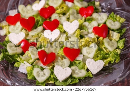 Fresh Salad on a plate with Red, Green and White Heart Shapes. Valentine's Day Theme