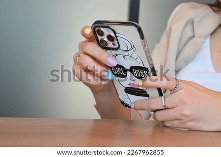 Close-up image of female hands using smartphone, working online., shopping, searching or social networks concept, hipster lady typing an sms message to her friends.