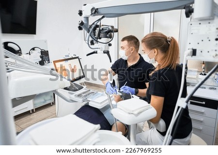 Dentist scanning patient's teeth with modern machine for intraoral scanning. Digital print of patient's teeth is on big screen. Modern high precision technologies. Concept of modern dentistry Royalty-Free Stock Photo #2267969255