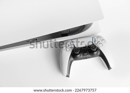 Next Generation game console and controller in close view Royalty-Free Stock Photo #2267973757