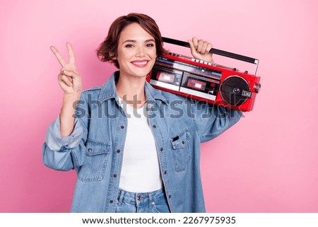 Photo of pretty sweet lady dressed denim jacket showing v-sign listening boom box isolated pink color background