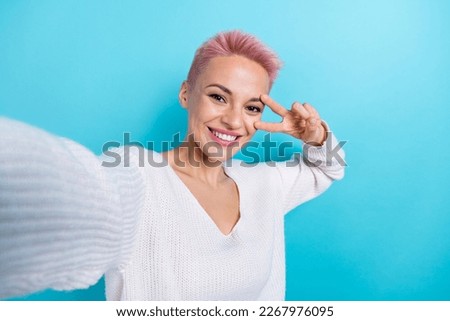 Photo of positive cheerful lovely lady wear white trendy clothes hand sign greeting symbol isolated on blue color background