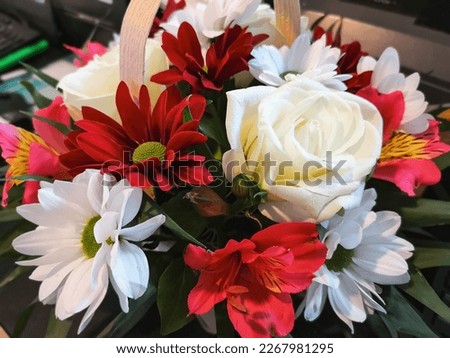 picture with a beautiful bouquet of flowers composed of chrysanthemums, lilies and roses, arranged in a basket, focus on the center with a soft effect around. birthday card, women's day, celebration