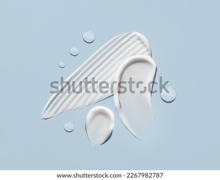 cosmetic smears cream texture on pastel blue background Royalty-Free Stock Photo #2267982787
