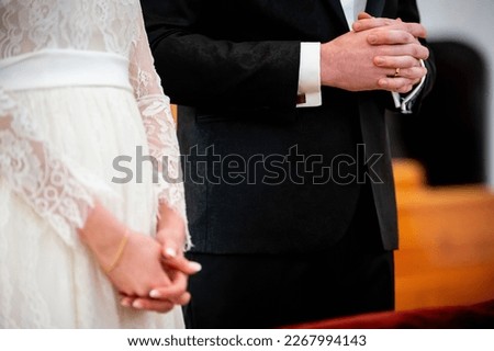 hands, wedding rings and marriage vows hands of the bride and groom during prayer