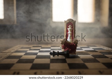 Red royal chair (Medieval Throne) miniature on chessboard. . Chess board game concept of business ideas and competition and strategy ideas concept. Selective focus Royalty-Free Stock Photo #2268020229