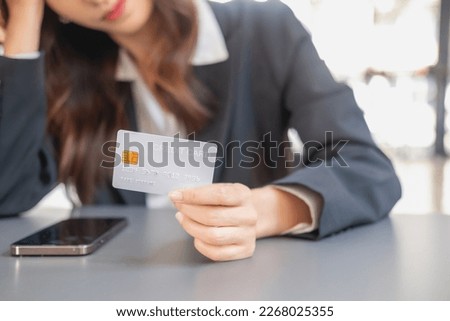 Young Asian woman shopping online using a credit card. for online payment within the house credit card payment concept
