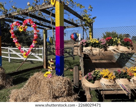 Festa Junina decoration, with flowers, hats, horse cart, hay and heart to take pictures.
