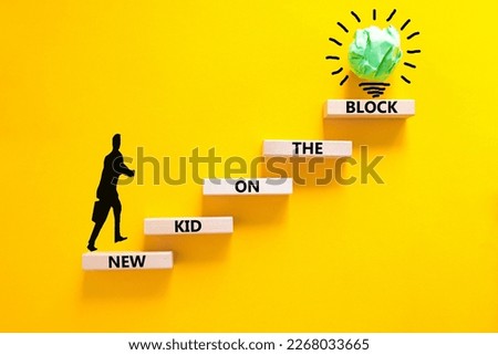New kid on the block symbol. Concept words New kid on the block on wooden blocks. Businessman icon. Beautiful yellow table yellow background. Business and new kid on the block concept. Copy space.
