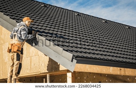 Black Ceramic House Tiles Roof Construction Theme. Contractor Roofer Checking on Finished Building Roof. Royalty-Free Stock Photo #2268034425
