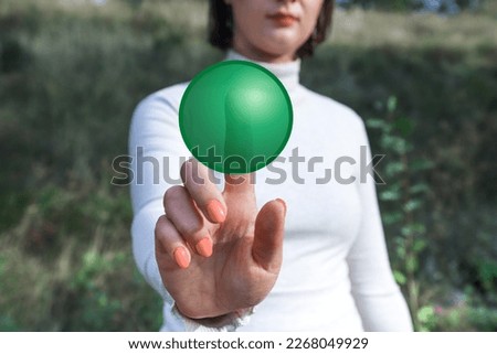 Woman pressing the green virtual button. Mockup photo with copy space. Concept of making a choice