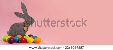  Wide Easter banner. Soft gray hare and eggs are multi-colored on a pink background.Holiday concept, congratulation, postcard, template,copy space, text, moc-up,handmade,spring,decoration,party,poster Royalty-Free Stock Photo #2268069557