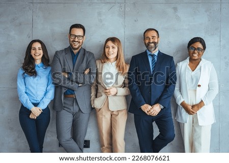 Portrait of multi-ethnic male and female professionals. Business colleagues are standing against wall. Confident individuals make a confident team. Diverse group of confident businesspeople