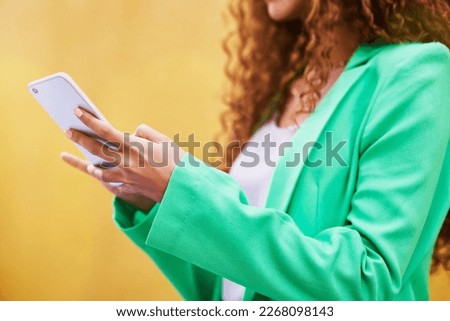 Woman, phone and hands typing on yellow background for communication, social media and tech chat. Closeup model, smartphone and network connection for mobile app, digital contact and search website