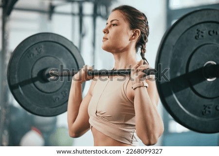 Gym training, barbell workout and woman doing muscle fitness performance, body strength exercise or bodybuilding. Strong girl, health club or bodybuilder weightlifting for athlete wellness lifestyle Royalty-Free Stock Photo #2268099327