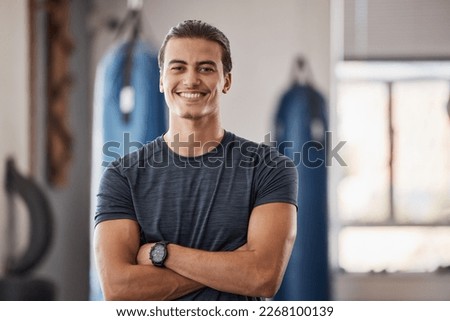 Gym, fitness and portrait of proud man standing with smile, motivation, health and energy for training. Coach, personal trainer or happy boxing club owner in studio for workout, coaching and wellness Royalty-Free Stock Photo #2268100139