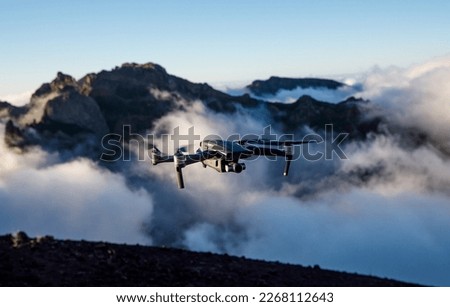 Drone with camera flying over the mountains Royalty-Free Stock Photo #2268112643