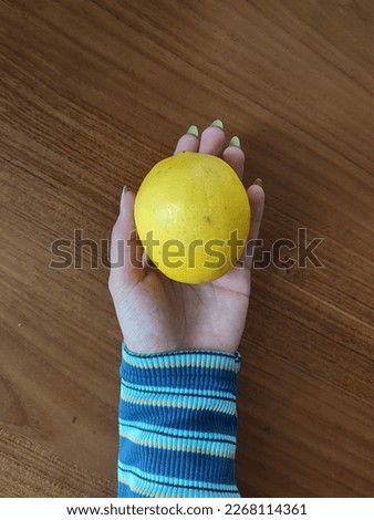 holding a lemon is commonplace Royalty-Free Stock Photo #2268114361