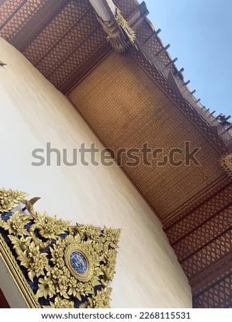 Thai temple entrance with delicate golden folk pattern in Bangkok