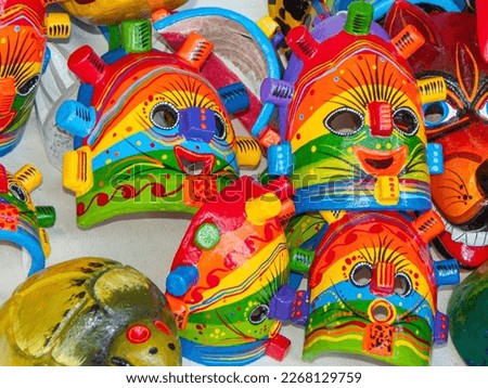 Souvenir colourful wooden masks of folk indigenous character Devil Huma (Uma) from Ecuador in the local artisan market Royalty-Free Stock Photo #2268129759