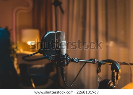A close up of a podcast microphone in a home podcast studio