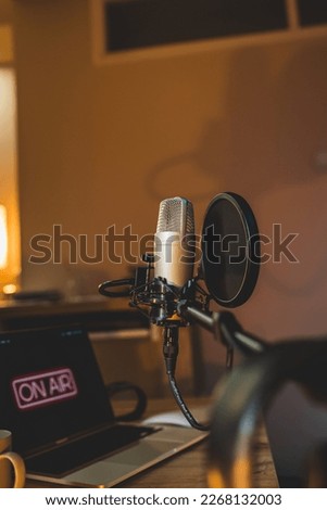 A close up of a podcast microphone in a home podcast studio