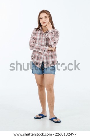 Portrait isolated cutout full body studio shot Asian cheerful happy female model in casual plaid long sleeves shirt shorts jeans and slippers standing crossed arms smiling posing on white background.
