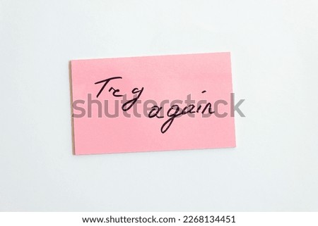 Try again inscription on pink paper