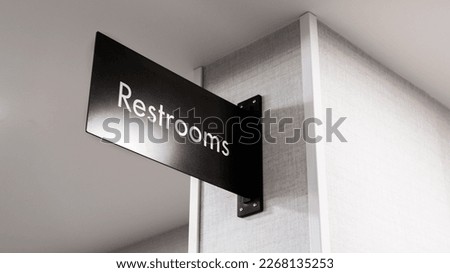 Restroom sign text on a wall