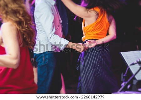 Couples dancing traditional latin argentinian dance milonga in the ballroom, tango salsa bachata kizomba lesson in the red and purple lights, festival, lesson class in dance school class academy
 Royalty-Free Stock Photo #2268142979