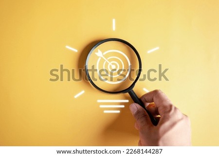 Magnifier glass focus to target objective with idea creative light bulb icon. planning development leadership and customer target group concept.	
