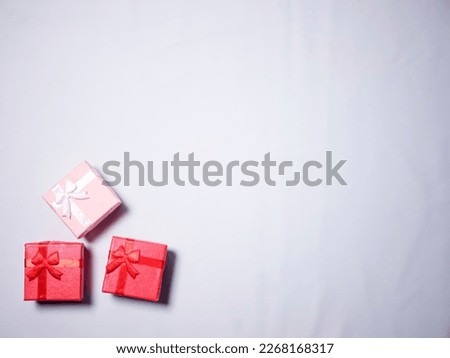 Red and pink mini gift box isolated on white background. with copy space for gift-giving or birthday-themed templates or designs