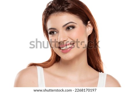 beautiful young smiling redhead women with makeup and long hair on a white studio background.