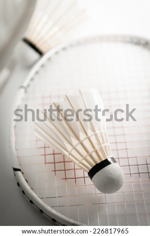 Shuttlecock on badminton racket closeup
