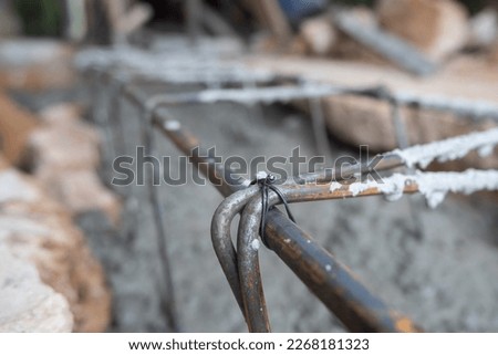 selective focus on the wire that binds the iron round bar for building in construction site, soft focus
