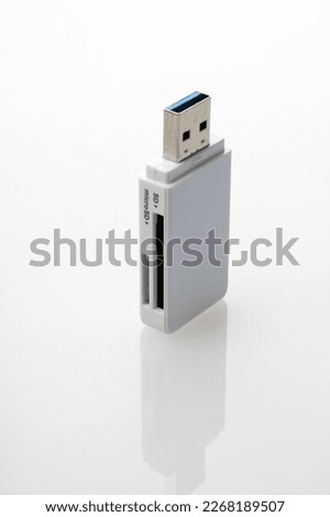 white USB card reader close-up on white background, adapter for memory cards