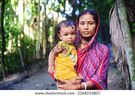 South asian hindu religious young mother holding her son, Child marriage is a problem, early maternity  Royalty-Free Stock Photo #2268193807