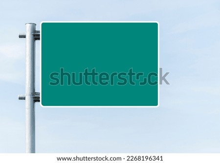 Mockup green road sign with blue sky background	