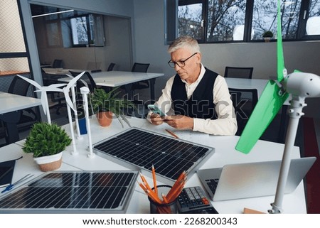 Male mature architect working on an ecological construction project in office