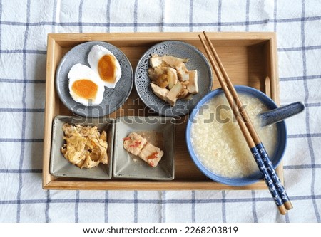 Typical Chinese breakfast, lunch meal. Millet Porridge with Fermented Beancurd, Pan Fry Char Choy (Pickled Mustard Root) Dried Shrimps Beancurd Slice, Scrambled Egg Fried Silverfish and Salted Egg